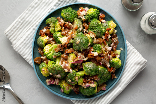 Homemade Broccoli Bacon Salad on a Plate on a gray background, top view. Flat lay, overhead, from above.