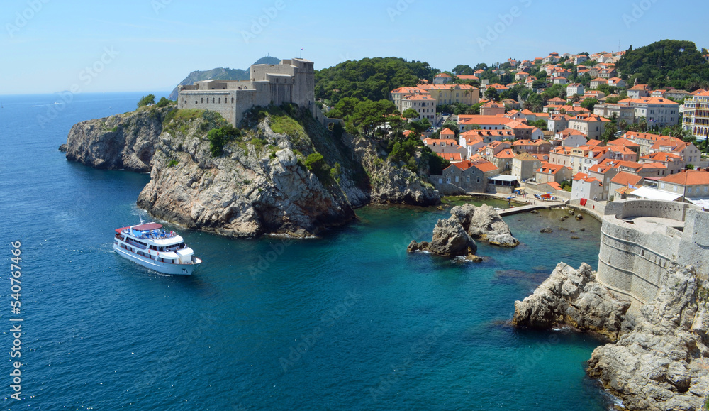 Dubrovnik  city wall ,Fort Lovrijenac and Wall small tourist trip boat on water