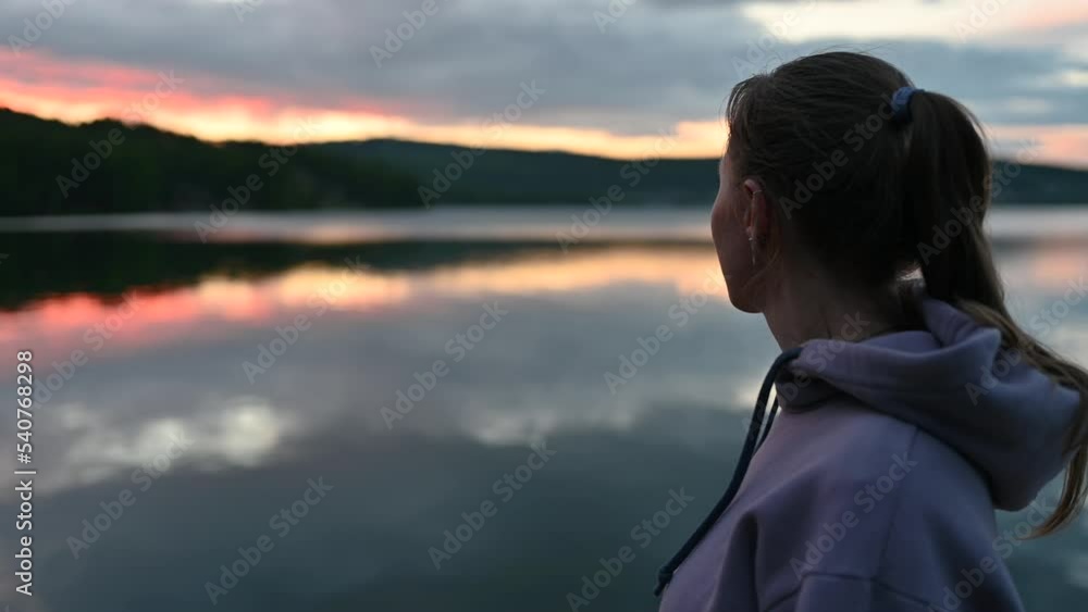 Woman sitting on the pier, closeup portrait, summer sunset Woman sitting on the pier, closeup portrait, summer sunset