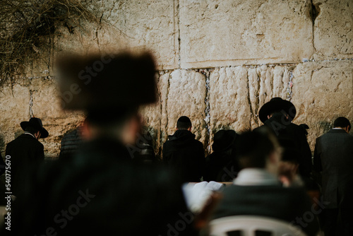 Orthodox Jewish man praying at the western wall photo