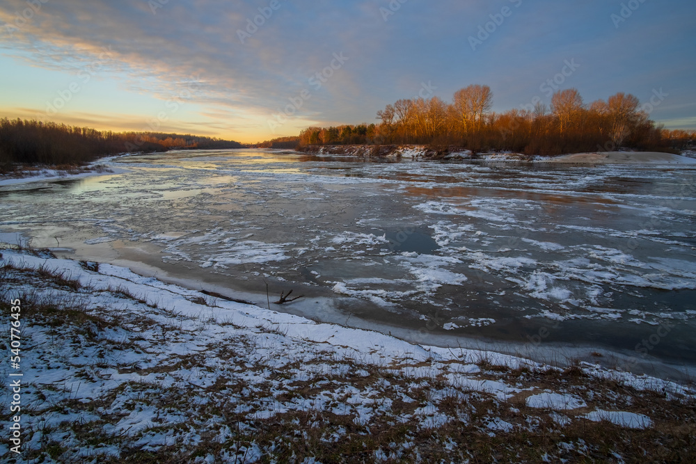 winter landscape with river and sun