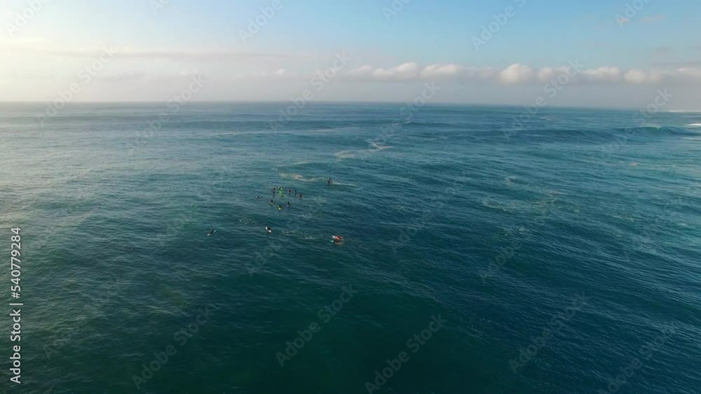 Aerial Lockdown Shot Of Tourists With Surfboards In Wavy Sea Against Cloudy Sky - Oahu, Hawaii Aerial Lockdown Shot Of Tourists With Surfboards In Wavy Sea Against Cloudy Sky - Oahu, Hawaii