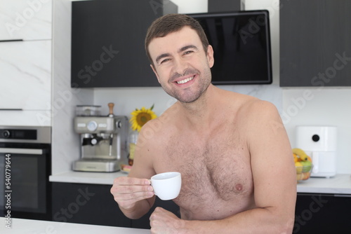 Idyllic shirtless man looking at camera in the kitchen  © ajr_images