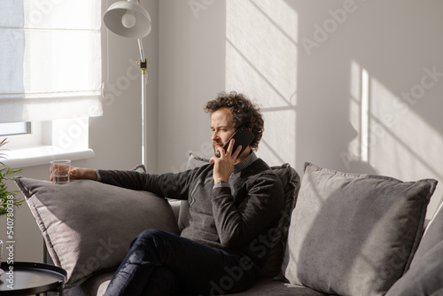The man smiles on the phone..Portrait of a business man who speaks on the phone. Serious young man solves working questions.