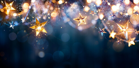 Christmas Lights - Stars String Hanging At Fir Branches In Abstract Defocused Background