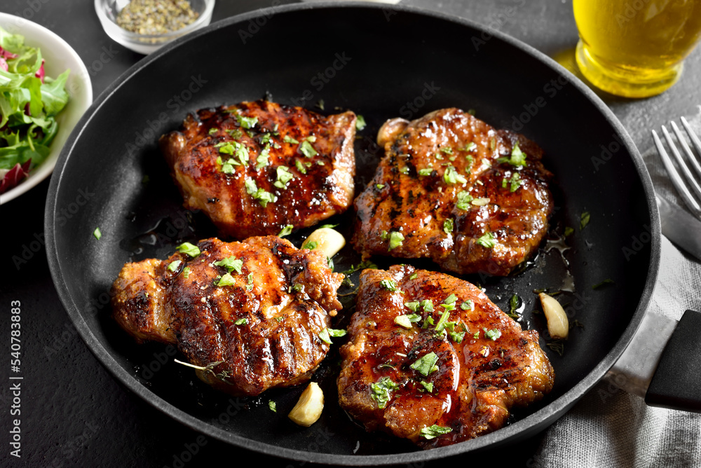 Fried pork steaks in cooking pan Fried pork steaks in cooking pan