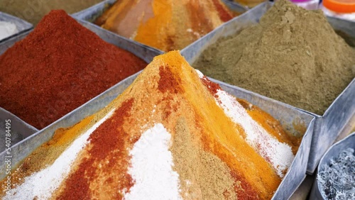 Colorful spice market in the weekly souk, in Rissani, South Morocco. Cinnamon, ginger, curcumin, paprika, pepper, and other spices in a traditional Moroccan bazaar. 4k