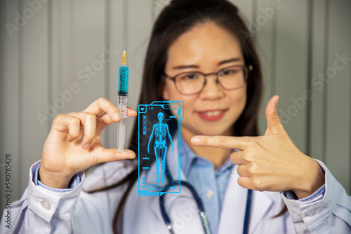 Female doctor holds syringe and bottle with vaccine
