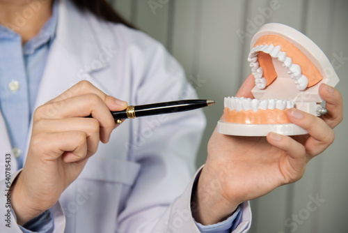 Asian young dentists are explaining about the dental root treatment