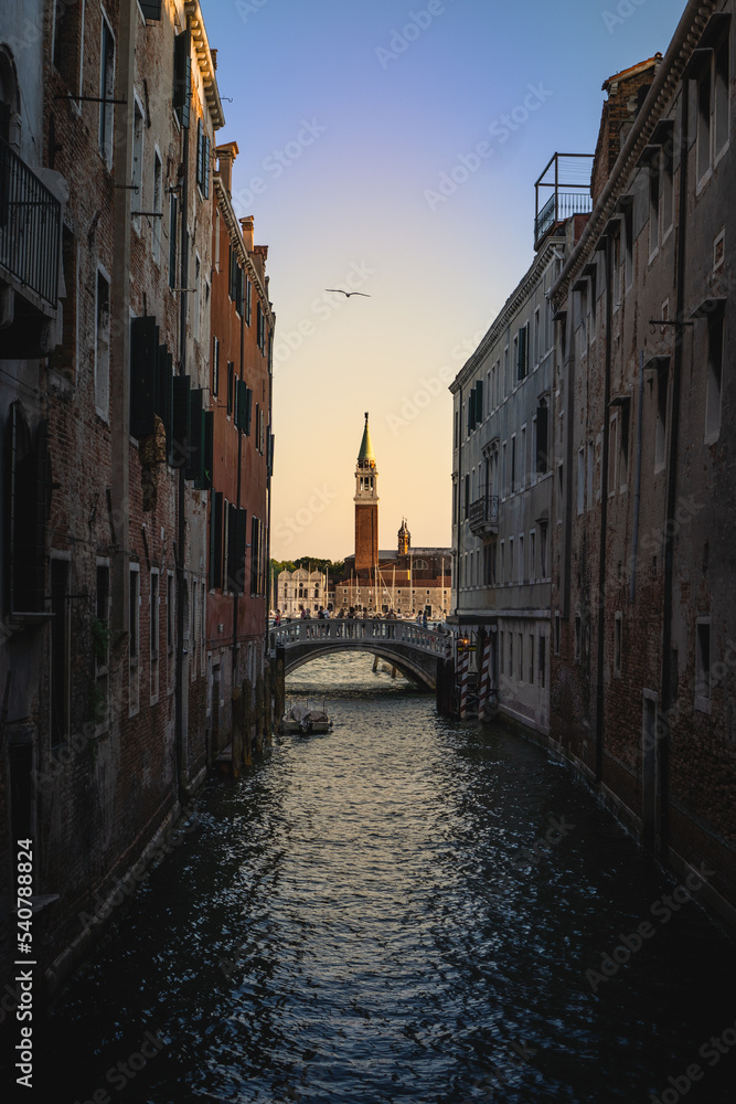 Photo of a canal in Venice, Italy with a colorful sky