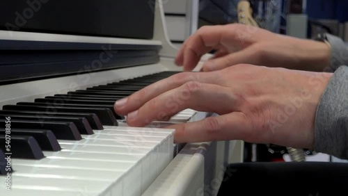 Hands of a pianist playing the piano close-up