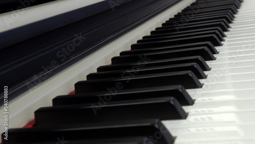 Piano keys close-up. The camera moves over the piano keys