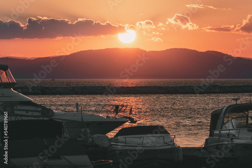 Sunset over Lake Champlain taken from Burlington, Vermont with Boats in the foreground photo