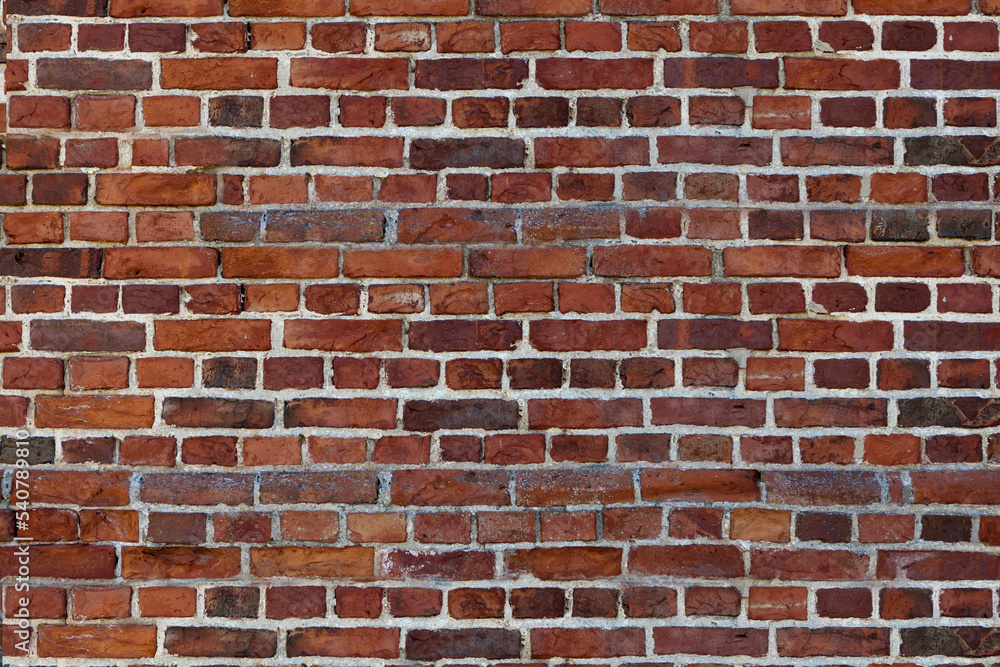 Old wall red briks tiled background, regular block texture. Wallpaper terracotta rustic wall surface Old wall red briks tiled background, regular block texture. Wallpaper terracotta rustic wall surface