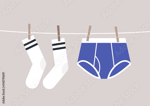 Underwear and socks pinned with clothespins to a cord drying outside