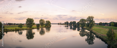 Panorama of the river Maas (Meuse) between Gelderland and North Brabant on summer evening, taken from the bridge between Ravenstein and Niftrik