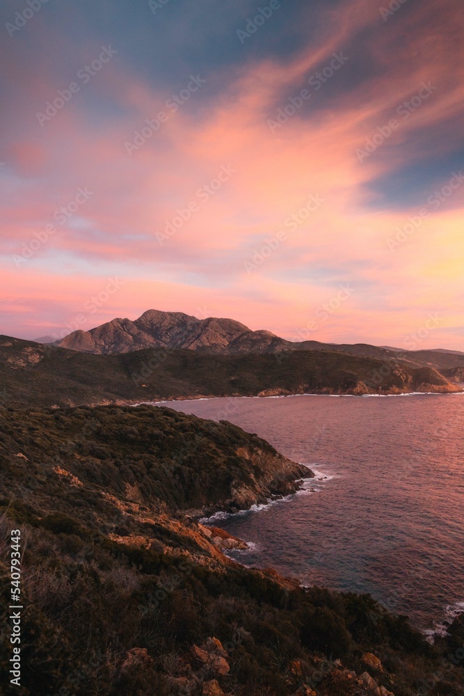 Mountains and sea at sunset in Corsica, on the way to the Capo Rosso, close to Piana. 
