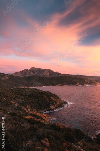 Mountains and sea at sunset in Corsica, on the way to the Capo Rosso, close to Piana. 