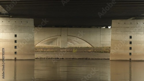 View of the architecturally complex substructure of a trough bridge viewed from the riverbank