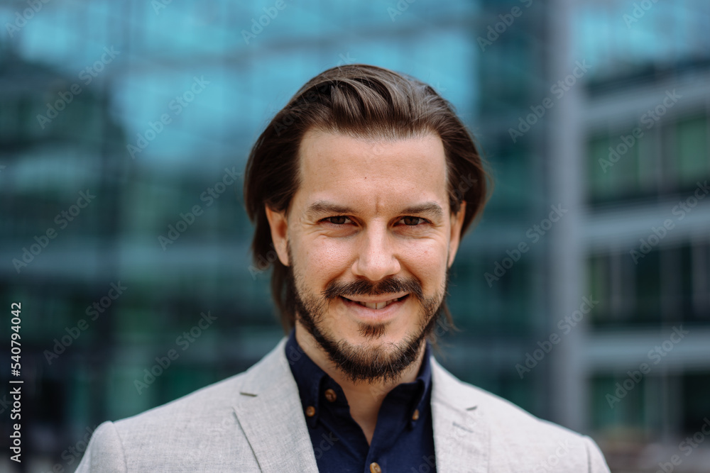 Serious adult businessman in formal wear posing towards modern office building Serious adult businessman in formal wear posing towards modern office building