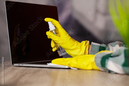 Close-up Of Woman Hand Cleaning Laptop At Office