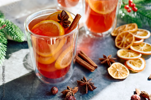 Christmas mulled wine with aromatic spices and citrus fruits. Traditional Christmas festive warming drink with orange, cinnamon, cardamom and anise.