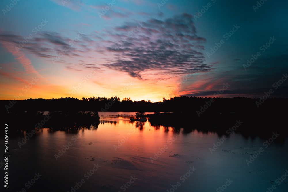 Red sunrise in the lake behind the forest Red sunrise in the lake behind the forest