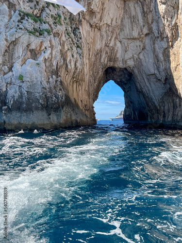 view of a yacht at the Faraglioni Rocks off Capri