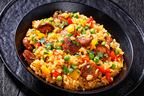 smoked sausages with rice and vegetables, top view