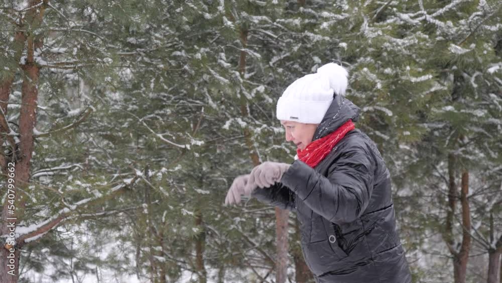 Woman playing with snow outdoors in the forest Woman playing with snow outdoors in the forest