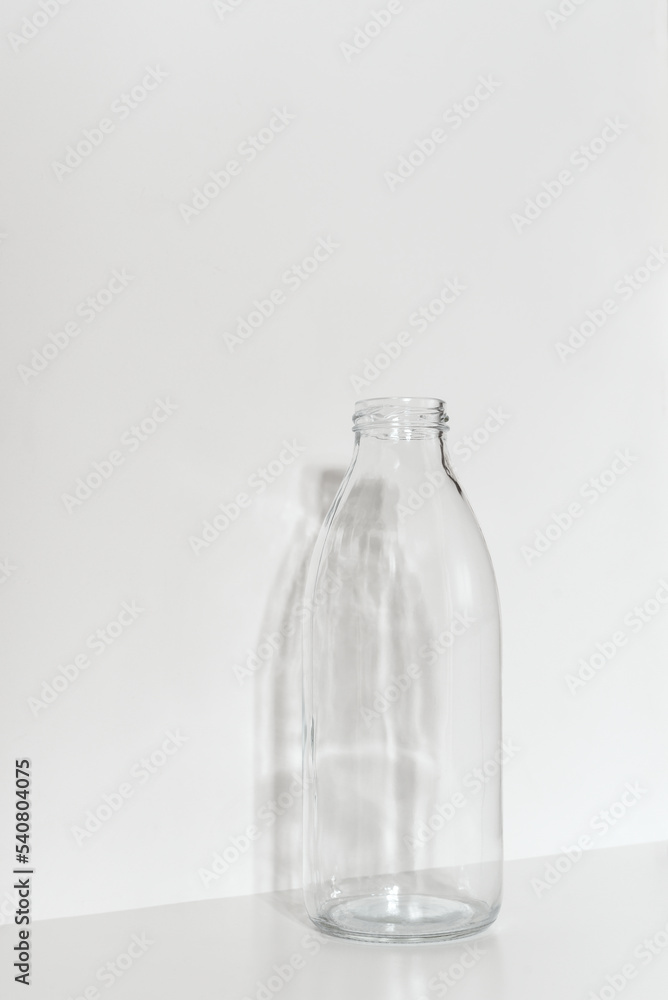 Glass bottle on a light background. Zero waste concept. Glass bottle on a light background. Zero waste concept.