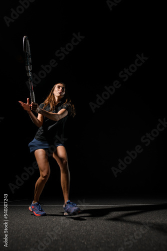 view of healthy woman with tennis racket waiting for tennis ball. © fesenko