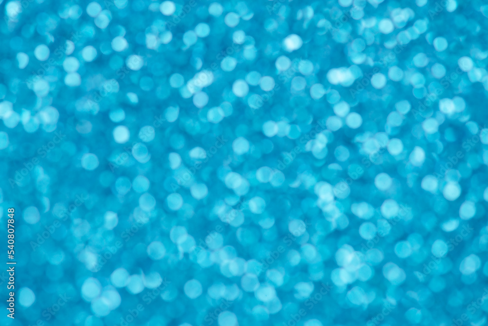 Blue bokeh background for christmas, defocused round lights and sunbeams, flare overlay
