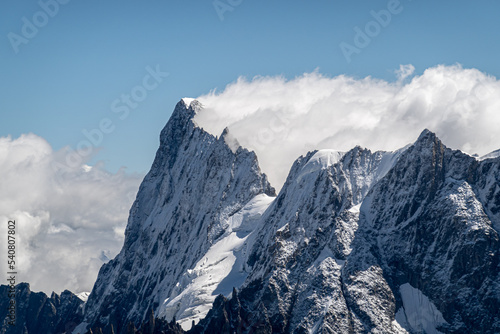 The peak of Grandes Jorasses emerging from the clouds