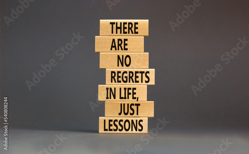 Regrets or lessons symbol. Concept words There are no regrets in life just lessons on wooden blocks on a beautiful grey table grey background. Business regrets or lessons concept. Copy space