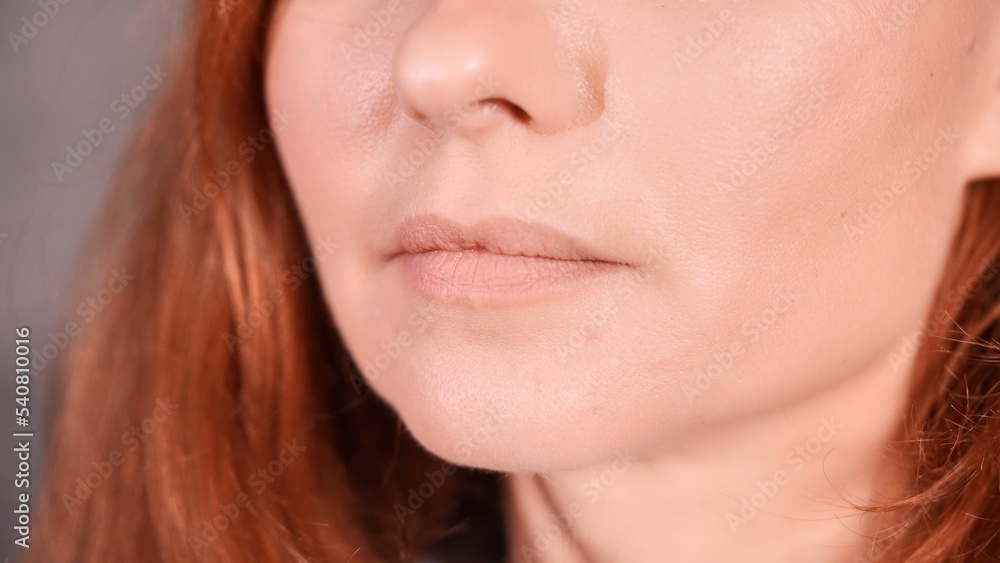 Obraz premium Closeup shot of a frown of a Caucasian female with red hair.