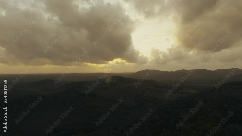 Drone flights forward and turning slowly in to the right toward amazing cloudy sunset in top of green Jungle in Sri Lanka, it was shot close to Mathugama. Drone flights forward and turning slowly in to the right toward amazing cloudy sunset in top of green Jungle in Sri Lanka, it was shot close to Mathugama.