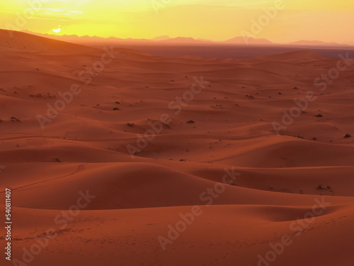 Amazing view of a gorgeous sunset over sand dunes of the Sahara desert, Morocco