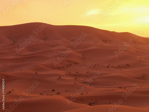 Amazing view of a gorgeous sunset over sand dunes of the Sahara desert, Morocco