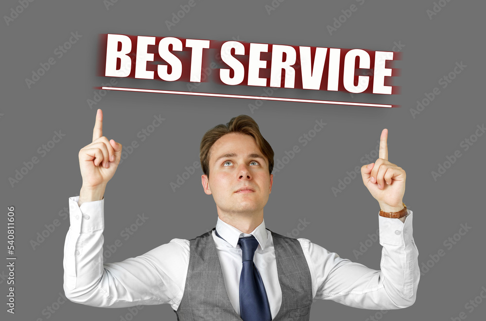 Businessman points fingers at the inscription - Best Service Businessman points fingers at the inscription - Best Service