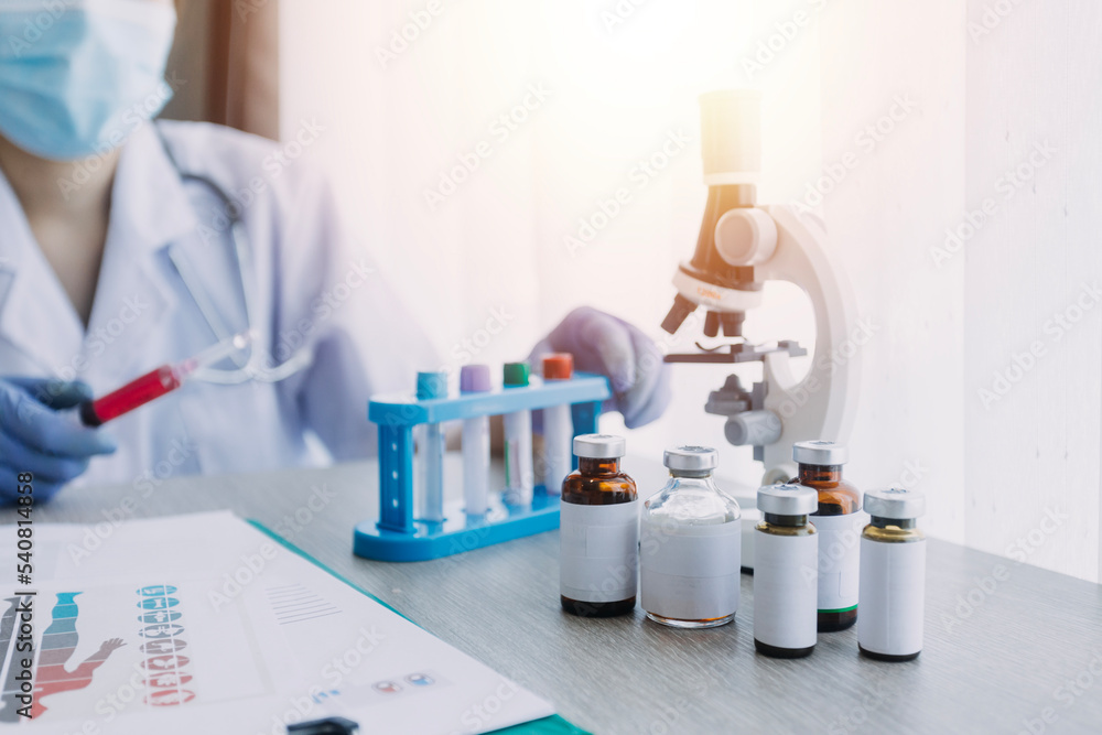 Fototapeta premium biochemical research scientist team working with microscope for coronavirus vaccine development in pharmaceutical research labolatory, selective focus
