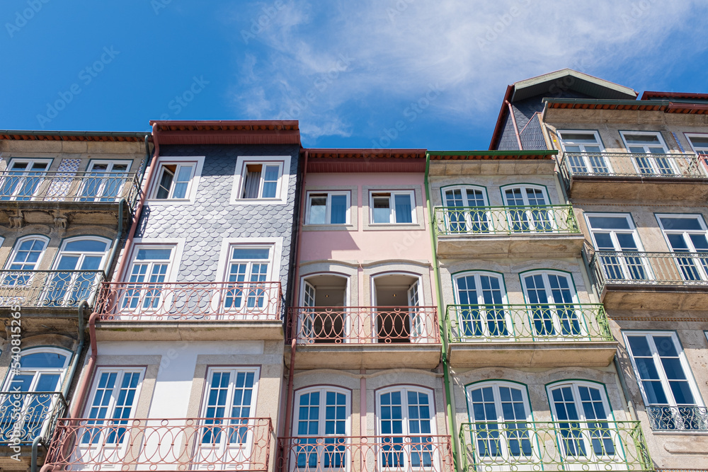 Oporto cityscape with colourful facades of old balconies landmark on a blue sunny sky in Oporto, Portugal