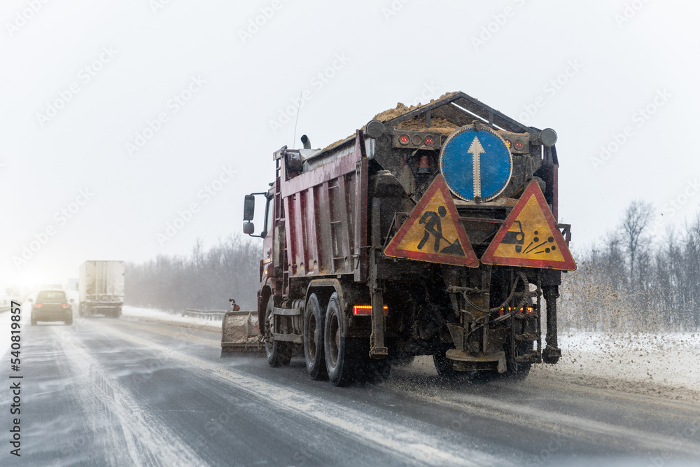 Snowplow truck removing dirty snow from city street or highway after heavy snowfalls. Traffic road situation. Weather forecast for drivers. Seasonal road maintenance. Bad conditions, slippery freeway Snowplow truck removing dirty snow from city street or highway after heavy snowfalls. Traffic road situation. Weather forecast for drivers. Seasonal road maintenance. Bad conditions, slippery freeway