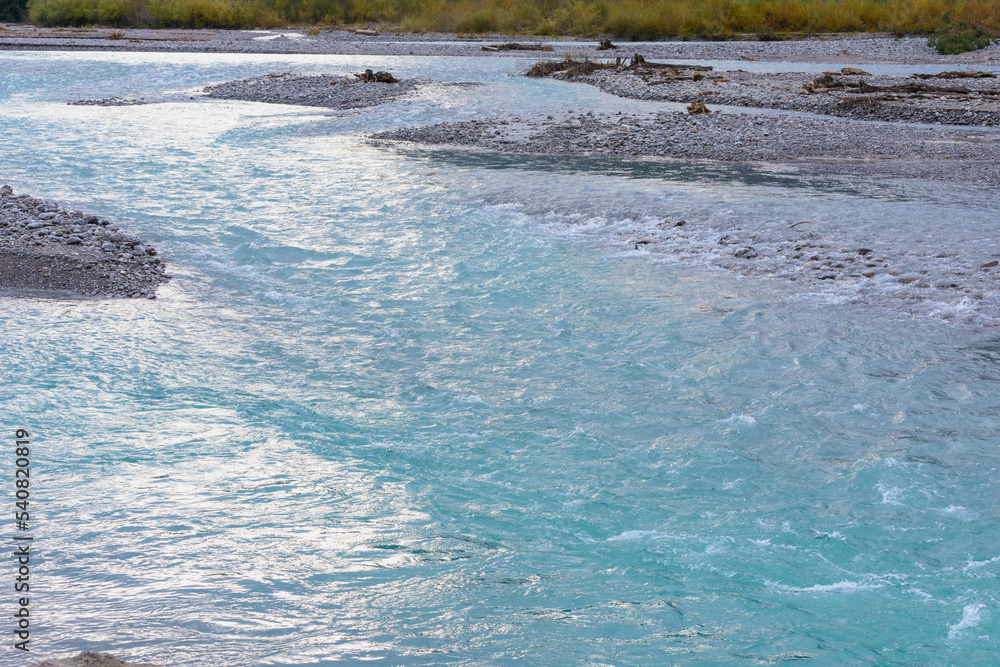 Turquoise glittering water of mountain river, copyspace