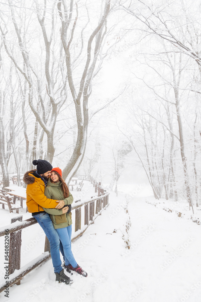 Couple spending snowy winter day outdoors