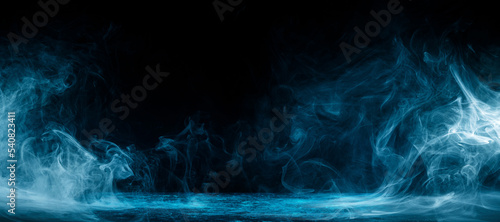 Abstract image of dark room concrete floor. Black room or stage background for product placement.Panoramic view of the abstract fog. White cloudiness, mist or smog moves on black background.  photo