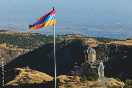 View of waving flag of Armenia with mountain landscape in the background, armenian tricolor flag in summer sunny day photo