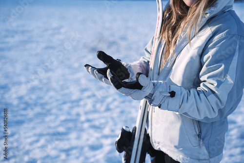 close up of girl's hands hesitating in the snow photo