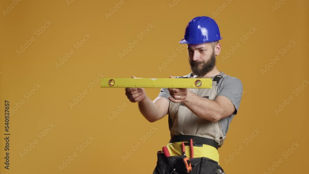 Construction builder working with water level tool to do measurement, using bench level to check balanced and flat walls. Working with level instrument to work even and stable, renovation. Construction builder working with water level tool to do measurement, using bench level to check balanced and flat walls. Working with level instrument to work even and stable, renovation.