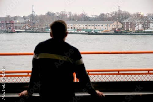 Silhouette of person looking at the The Staten Island ferry terminal in Manhattan New York
